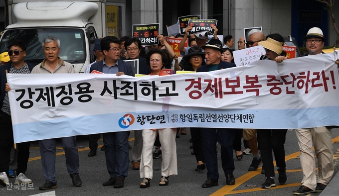 23일 오후 서울 종로구 일본대사관 앞에서 항일독립선열선양단체연합회 회원들이 일본의 경제보복 중단을 요구하는 집회를 마치고 구호를 외치며 거리행진을 하고 있다. 홍인기 기자