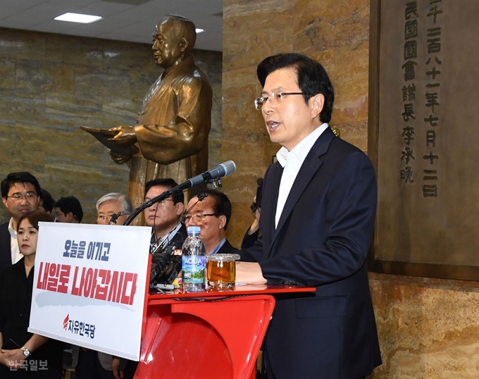 [저작권 한국일보] 자유한국당 황교안 대표가 14일 오후 국회 로텐더홀 이승만 전 대통령 동상 앞에서 광복절 대국민 담화문을 발표하고 있다. 그는 문재인 정부의 정책 대전환을 요구했지만 지금의 경제ㆍ안보 위기를 극복할 합리적이고 적절한 대응책을 제시하지는 못했다. /오대근기자