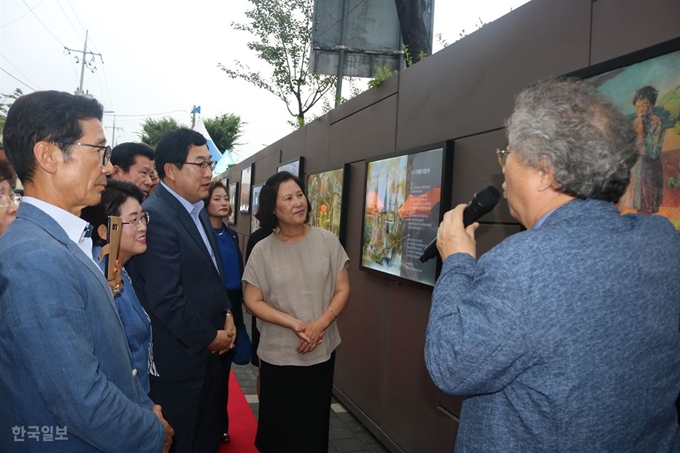 [저작권 한국일보]이채원(오른쪽 1번째) 이인성기념사업회장이 21일 대구 중구 삼덕동 삼덕지하보드 앞에 조성된 이인성 야외 갤러리에 걸린 이인성 화가 작품을 설명하고 있다. 이날 열린 개관식을 시작으로 내년 3월 30일까지 '사과나무', '계산성당' 등 이인성 화가의 대표 작품 18점을 만나볼 수 있다. 윤희정기자 yooni@hankookilbo.com