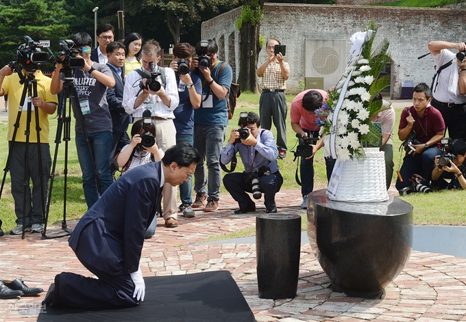 지난 2015년 8월 12일 서울 서대문형무소역사관을 찾은 하토야마 유키오(鳩山由紀夫) 전 일본 총리가 서대문형무소에서 순국한 애국선열 추모비에 헌화한 후 무릎을 꿇고 조의를 표하고 있다. 뒤에 보이는 건물은 애국지사들이 처형 당했던 사형장. 신상순 선임기자