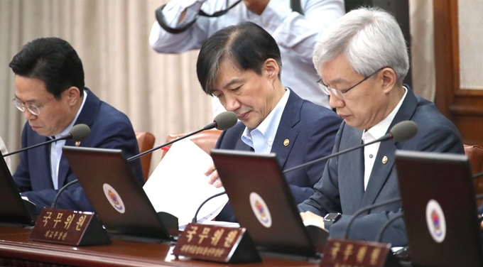 조국 법무부 장관이 24일 정부서울청사에서 열린 국무회의에 참석해 자료를 살펴보고 있다. 연합뉴스