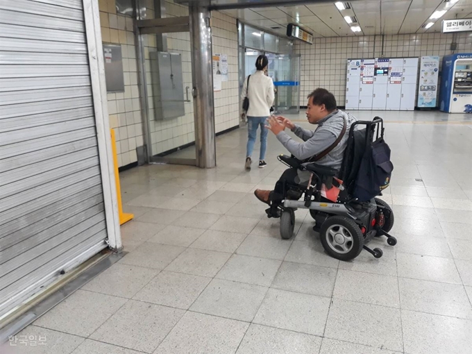 지난달 23일 오전 전동휠체어를 타는 배재현씨가 서울지하철 4호선 수유역에서 점포 바로 옆에 붙어있어 찾기 어려운 급속충전기에 대해 설명하고 있다. 손성원 기자