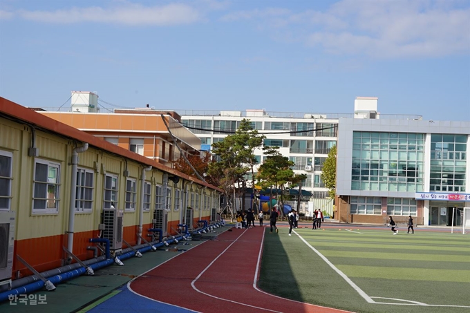 경북 포항시 북구 흥해읍 흥해초등학교 학생들이 12일 포항지진으로 학교 건물이 파손돼 임시 교실로 지어진 컨테이너 옆 운동장에서 체육수업을 받고 있다. 포항=김정혜 기자 kjh@hankookilbo.com