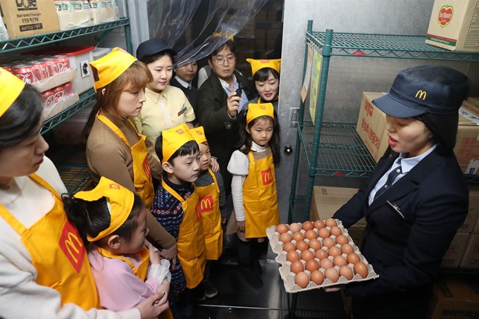 19일 서울 맥도날드 상암DMC점에서 열린 '맥도날드 주방 공개의 날' 행사에서 참가자들이 냉장실 관리 상태에 대한 설명을 듣고 있다. 연합뉴스