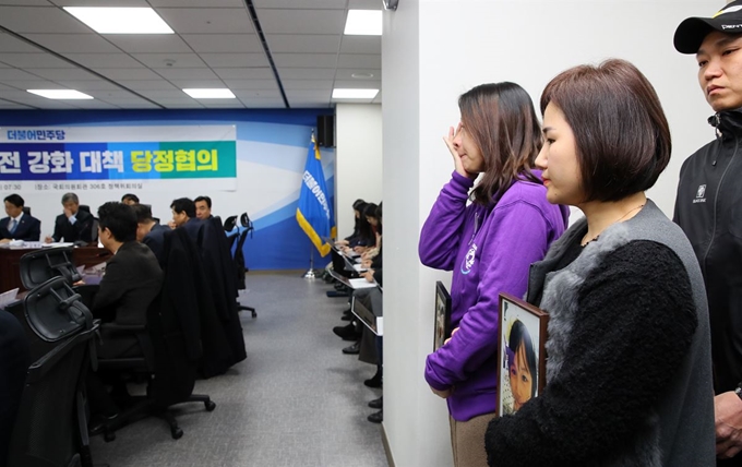 교통사고로 아이를 잃은 태호-해인이 가족이 26일 국회 의원회관에서 열린 어린이 교통안전 강화 대책 당정협의를 지켜보며 눈물을 흘리고 있다. 연합뉴스