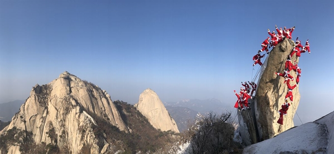 22일 서울 북한산 만경대에서 산타클로스 복장을 한 쌩곰산악회와 멀티암벽산악회 대원들이 2020년 산악인들의 안전산행을 기원하고 다가오는 크리스마스를 축하는 의미로 퍼포먼스를 하고 있다. 연합뉴스