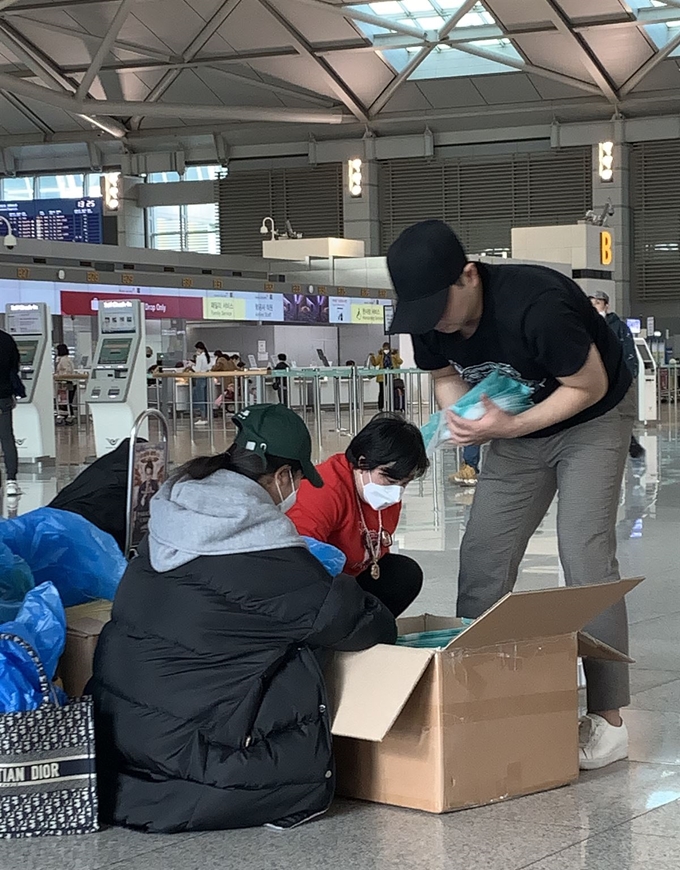 우한폐렴(신종 코로나바이러스 감염증) 확진자가 아시아를 넘어 유럽, 미주 등 전 세계로 확산되고 있는 28일 오후 인천국제공항 출국장에서 중국여행자들이 한국에서 구입한 마스크를 비닐봉투에 옮겨 담고 있다. 뉴스1