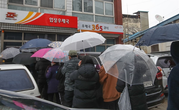 지난달 28일 오후 충남 천안시 서북구 입장우체국에서 시민들이 코로나19 예방용 마스크를 구매하고 있다. 천안=연합뉴스