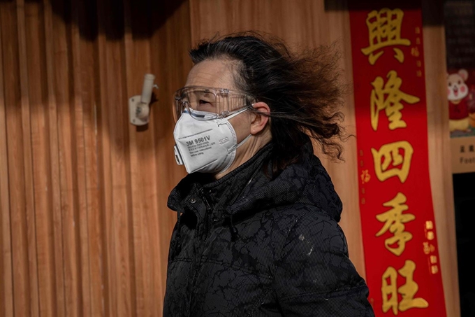 중국 베이징에서 3일 마스크에 고글을 착용한 여성이 바삐 걸어가고 있다. 베이징=AFP 연합뉴스