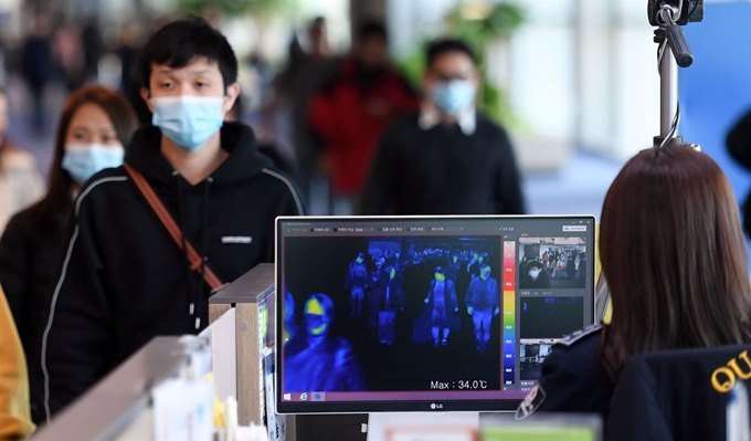 인천국제공항 입국장에서 질병관리본부 국립검역소 직원들이 승객들의 체온을 측정하고 있다. 한국일보 자료사진