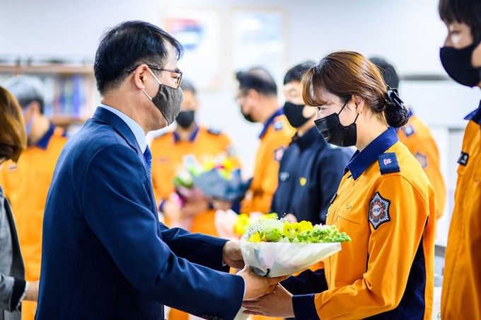 장충남(왼쪽) 경남 남해군수는 전국 소방공무원 신분이 국가직으로 전환된 지난 1일 남해소방서를 찾아 소방대원들에게 꽃다발을 전달하며 축하했다. 장 군수는 이날 ‘착한 꽃소비 운동’ 확산을 위해 꽃다발을 축하선물로 전달했다. 남해군 제공