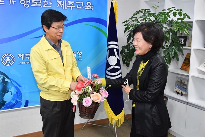 지난달 4일 김태석 제주도의회 의장으로부터 ‘플라워버킷챌린지 운동’ 동참 주자로 지명된 이석문 제주도교육감이 교육감실을 방문한 김애숙 도의회 총무담당관에게 꽃바구니를 전달받고 있다. 제주도교육청 제공.