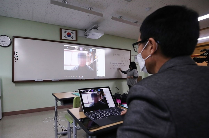 9일 오전 서울 성동구 도선고등학교 3학년 7반 교실에서 한 교사가 온라인 수업을 시작하며 출석 확인을 하고 있다. 교육부에 따르면 이날 전국 중학교 3학년, 고등학교 3학년이 온라인 개학을 한다. 16일에는 고 1∼2학년, 중 1∼2학년, 초 4∼6학년이 원격수업을 시작하고, 20일에는 초 1∼3학년이 온라인 개학한다. 연합뉴스