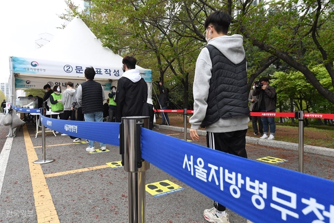 20일 서울 영등포구 서울지방병무청 앞에 설치된 선별진료소에서 병역판정 검사 대상자들이 간격을 유지한 채 줄을 서서 순서를 기다리고 있다. 고영권 기자