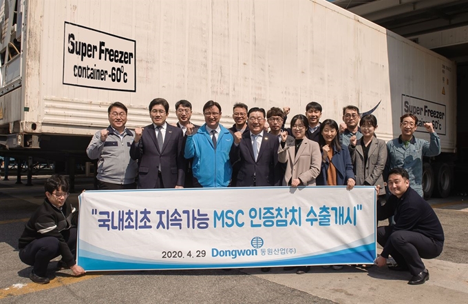 29일 동원산업 임직원들이 MSC 인증 참치 수출 물량이 실린 냉동 컨테이너 앞에 모여 기념 사진을 찍고 있다. 동원그룹 제공