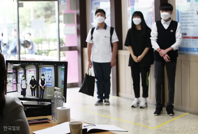 고등학교 1학년 및 중학교 2학년, 초등학교 3, 4학년을 대상으로 한 3차 등교개학일인 3일 오전 한 고등학교에서 교사가 열화상 카메라로 등교하는 학생들의 체온을 측정하고 있다. 이한호 기자