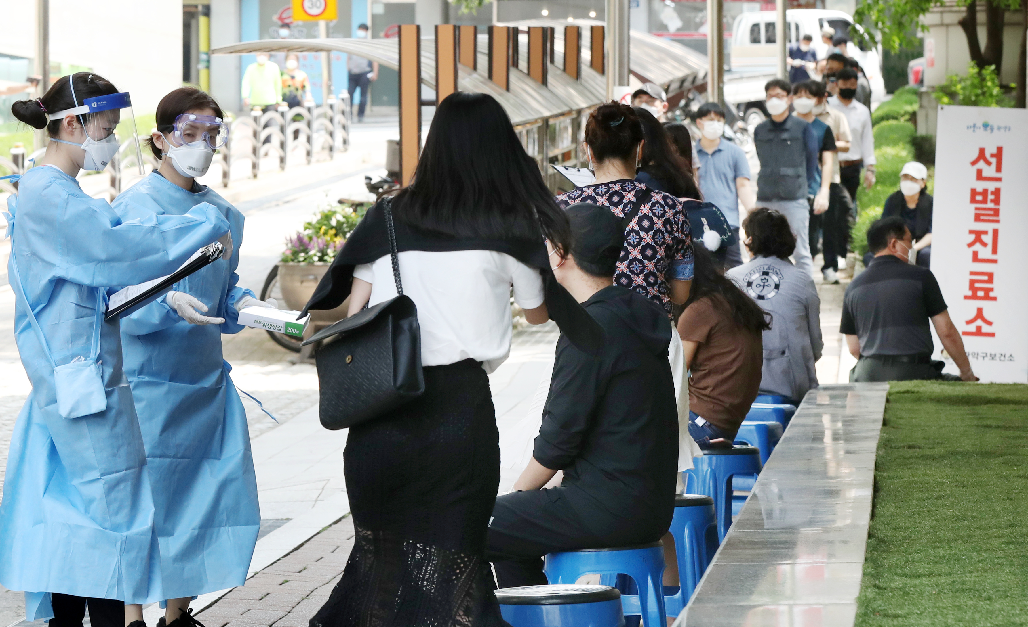 지난 5일 오후 서울 관악구 보건소에서 의료진들이 신종 코로나바이러스 감염증(코로나19) 의심 증상으로 보건소를 찾은 시민들을 돌보고 있다. 뉴스1