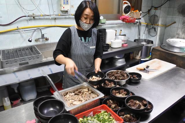 국밥 뚝배기에 순대를 담는 모습.