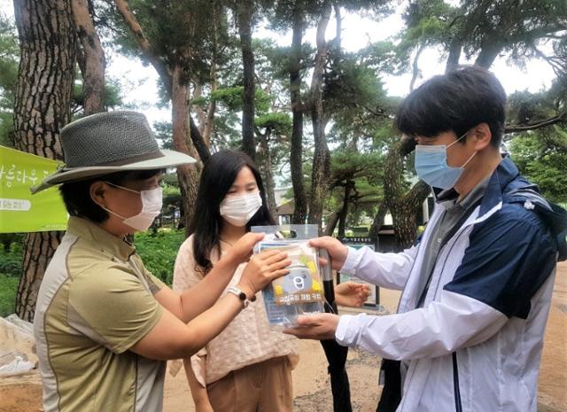 경주국립공원 직원들이 탐방로에서 탐방객에게 비대면 체험키트를 증정하고 있다. 경주국립공원 제공