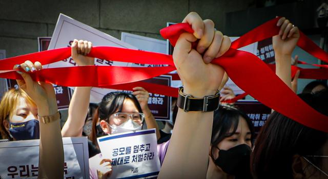 지난달 11일 서울 서초구 서울중앙지법 앞에서 열린 텔레그램 성착취 공동대책위원회 기자회견에서 참석자들이 함께 연대의 의미로 끈을 잇는 퍼포먼스를 하고 있다. 뉴스1