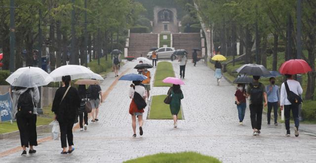 19일 비가 내린 가운데 서울 서대문구 연세대 교정 내 학생들이 우산을 쓰고 걷고 있다. 연합뉴스