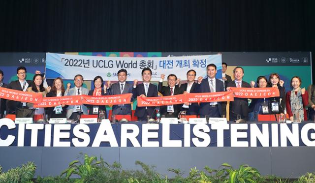 지난해 11월 15일(현지시간) 남아공 더반에서 열린 UCLG총회에서 2022년 세계총회 대전유치가 확정된 후 허태정(왼쪽 일곱번째)시장을 비롯한 유치단원들이 현장에서 환영행사를 하고 있다. 대전시 제공