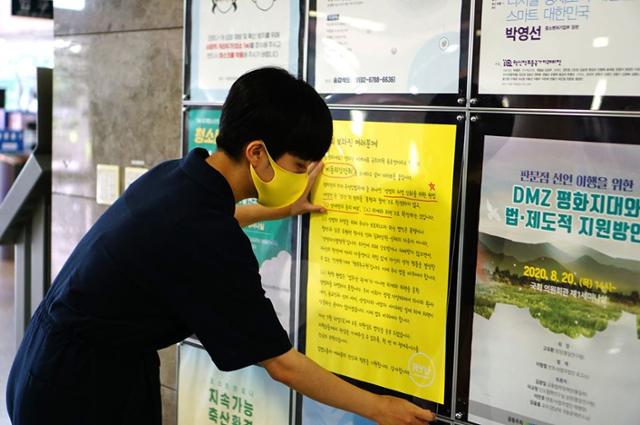 류호정 정의당 의원이 10일 국회 의원회관에 ‘비동의강간죄’에 대해 설명하는 포스터를 부착하고 있다. 류호정 페이스북 캡처