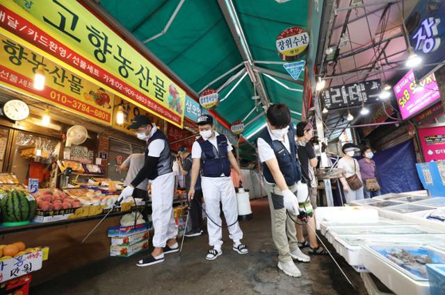 18일 오전 서울 성북구 사랑제일교회 인근 장위전통시장에서 방역업체 직원들이 방역을 하고 있다. 뉴시스