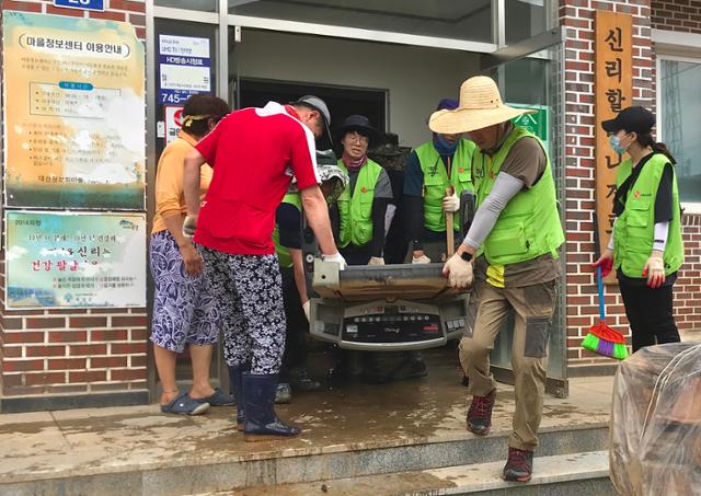 캠코(한국자산관리공사 사장 문성유) 광주전남지역본부 직원들이 12일 기록적인 폭우로 극심한 피해를 입은 전남 곡성군 신리마을에서 침수가구 세척 등 자원봉사활동을 펼치고 있다. 캠코 제공