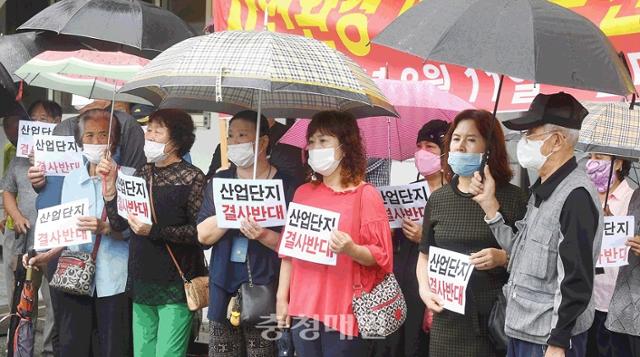 충북 청주시 흥덕구 강내면 주민들이 지난달 11일 청주시청 본관 앞에서 장맛비가 내리는 가운데 집회를 열고 '청주 하이테크밸리 산업단지'조성사업 철회를 촉구하고 있다. 이들은 "주거, 학교 밀집지역에 산업단지 조성을 추진하는 것 자체가 문제"라고 주장했다. 충청매일 제공