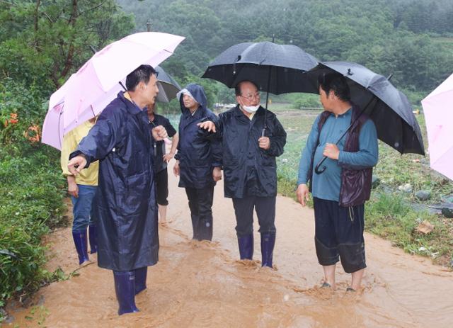 단양군 관계자들이 지난달 초 폭우로 도로가 끊기고 농경지가 침수된 어상천면의 한 마을을 찾아 피해 상황을 살피고 있다. 단양군 제공