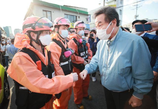 이낙연 더불어민주당 대표가 지난 22일 서울 동대문구 청량리 청과물시장 화재현장을 찾아 소방대원들과 코로나 주먹인사하고 있다. 국회사진기자단