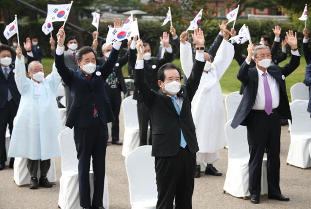 정세균 국무총리가 3일 오전 서울 경복궁 내 국립민속박물관 앞 광장에서 열린 제4352주년 개천절 경축식에서 현정회 홍석창 회장과 의인 진창훈·박광진씨의 선창으로 모든 참석자와 함께 만세삼창을 하고 있다. 연합뉴스