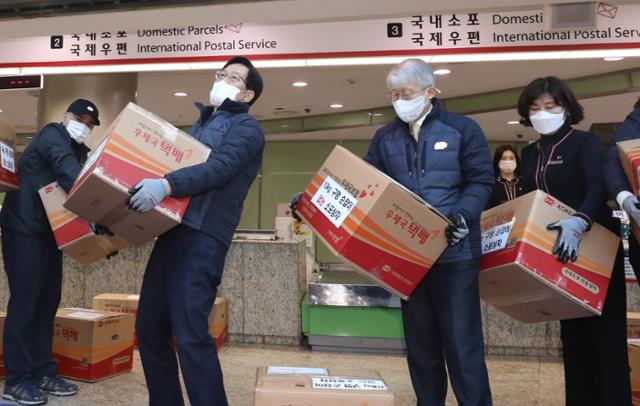 23일 서울 중구 서울중앙우체국 우편창구에서 최기영 과학기술정보통신부 장관과 더불어민주당 신동근 의원 등이 구멍손잡이가 없는 택배상자와 구멍 손잡이가 있는 소포상자를 비교해 보고 있다. 홍인기 기자