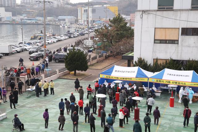 경북 포항시 남구 구룡포읍 주민들이 지난 27일 읍민도서관에 설치된 신종 코로나바이러스 감염증 기동 선별진료소에서 검사를 받기 위해 줄을 서서 기다리고 있다. 포항시 제공