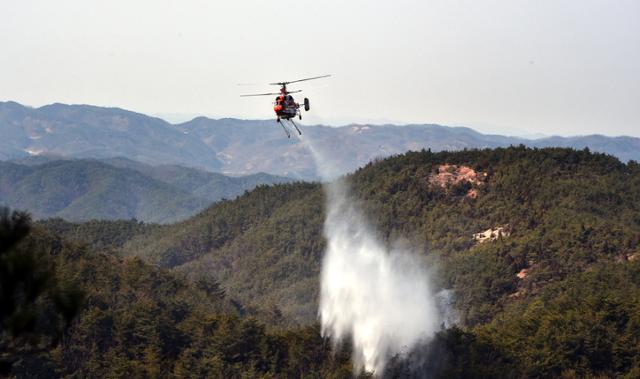 산림청 산림헬기가 22일 오전 경북 안동시 임동면 산불현장에서 물을 투하하며 산불을 진화하고 있다. 산불 발생 21시간 만에 축구장 350여개 면적인 산림 250㏊를 태우고 주불이 진화됐다. 뉴시스