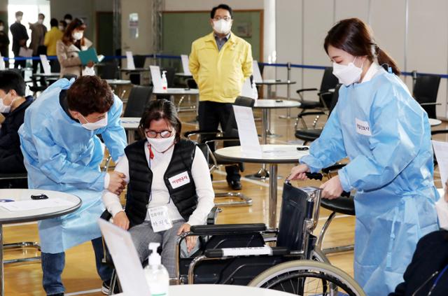 19일 오전 인천시 연수구 선학체육관에 마련된 신종 코로나바이러스 감염증(코로나19) 지역예방접종센터에서 열린 모의훈련에서 센터 관계자들이 백신 이상반응을 보이는 접종자 발생 상황에 대처하는 훈련을 하고 있다. 연합뉴스