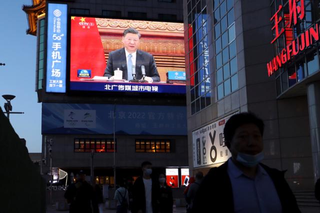 시진핑 중국 국가주석이 16일 프랑스, 독일 정상과 기후변화 대응 화상회의를 하는 장면이 베이징 도심의 대형 스크린에 비치고 있다. 베이징=EPA 연합뉴스