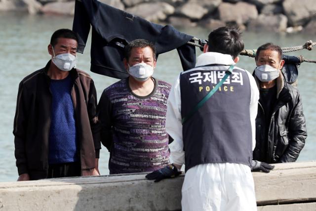 지난달 21일 오전 인천 중구 인천해양경찰서 전용부두에서 해양경찰관이 옹진군 소청도 인근 해상에서 불법 조업을 하다 나포된 중국어선 선원들을 상대로 조사를 하고 있다. 연합뉴스