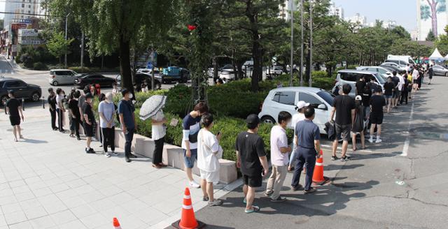 12일 대구지역 신종 코로나바이러스 감염증(코로나19) 신규 확진자가 한 달여 만에 37명이 추가돼 방역에 비상이 걸렸다. 이날 오전 달서구보건소에 마련된 선별진료소에서 시민들이 줄지어 코로나19 진단검사를 기다리고 있다. 뉴스1