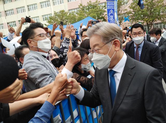 더불어민주당 대선주자인 이재명 경기지사가 26일 전북 완주군 우석대학교 체육관에서 열린 더불어민주당 대선 후보 선출을 위한 전북 합동연설회를 찾은 지지자들과 주먹 인사를 하고 있다. 완주=연합뉴스