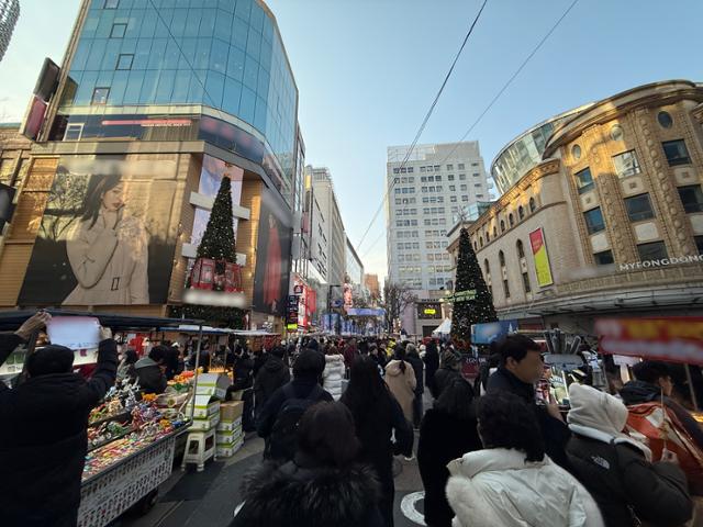 "내년은 달라졌으면"… 성탄 전야, 명동은 차분했고 광화문은 뜨거웠다