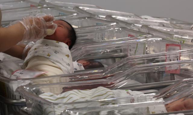 A nurse takes care of newborns at a hospital in Incheon on Feb. 26. Newsis