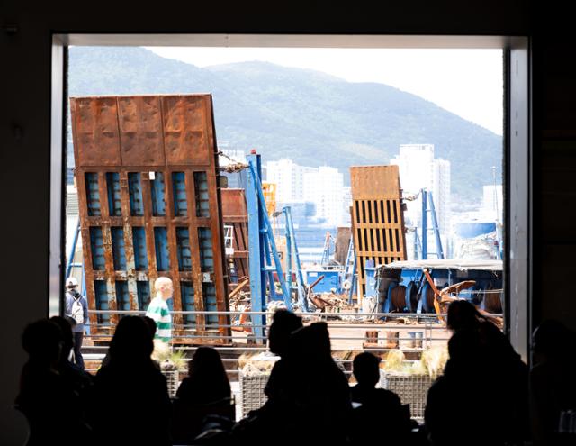 Busan harbor is visible through the entrance of the Momos Coffee Yeongdo branch. Korea Times file