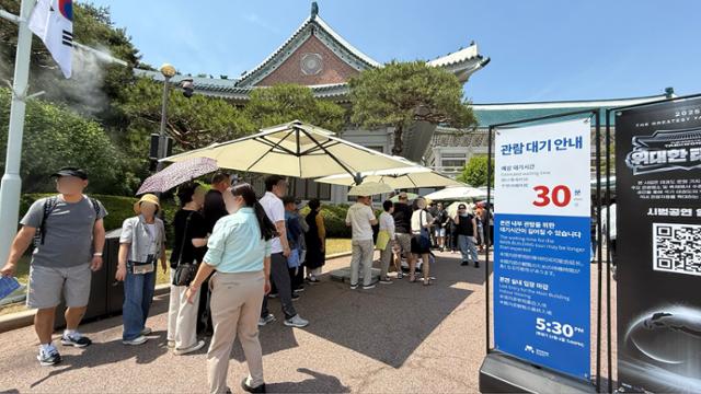 Visitors wait to enter the former presidential compound in Seoul’s Jongno District, Friday. Korea Times