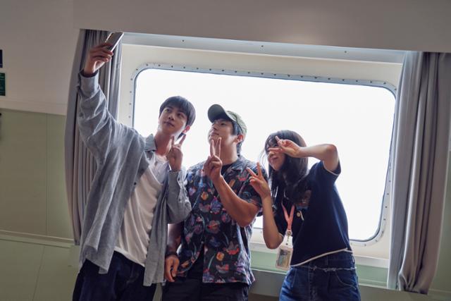 Cast members of the Netflix variety show 'Kian's Bizarre B&B,' produced by Studio Modak. From left: Jin of BTS, Kian84, and Ji Ye-eun. Courtesy of Netflix