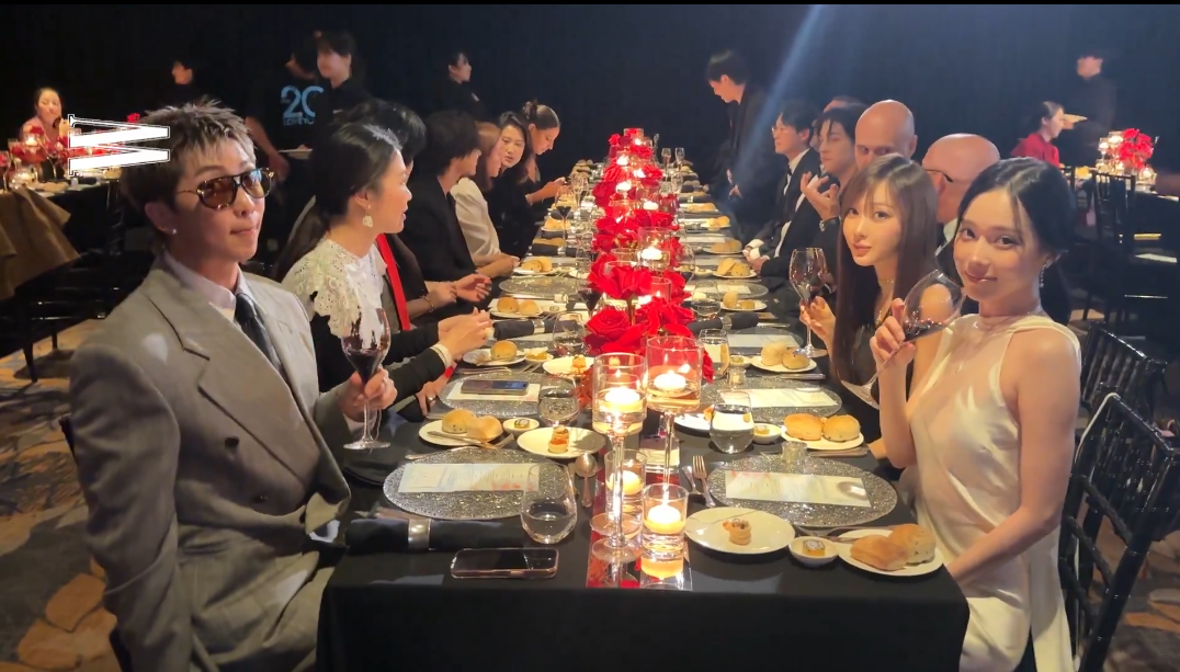 BTS member RM, front left, and aespa’s Winter, front right, look toward the camera during W Korea’s breast cancer awareness charity event at the Four Seasons Hotel in Jongno District, central Seoul, on Wednesday. Captured from W Korea’s Instagram