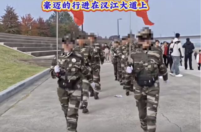 Chinese tourists march in military-style uniforms during the International Walking Exchange event at Yeouido Hangang Park in Seoul on Oct. 31. Captured from online community