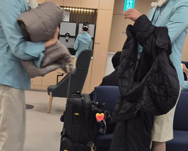 Flight attendants remove winter jackets before work on Jan. 14, amid freezing weather. Courtesy of Kwon Soo-jung, head of Asiana Airlines union