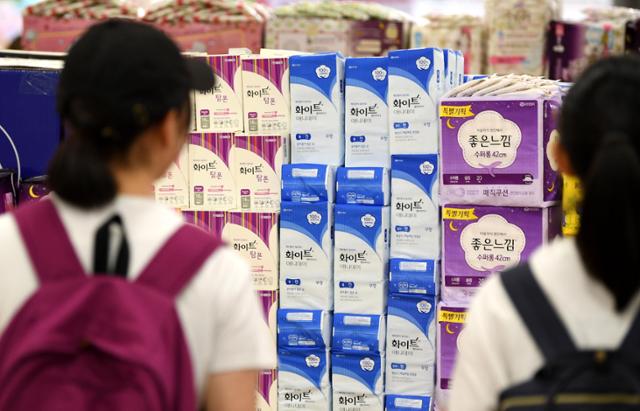 A woman browses sanitary pad products at a large supermarket in Seoul. Korea Times photo by Hong In-gi